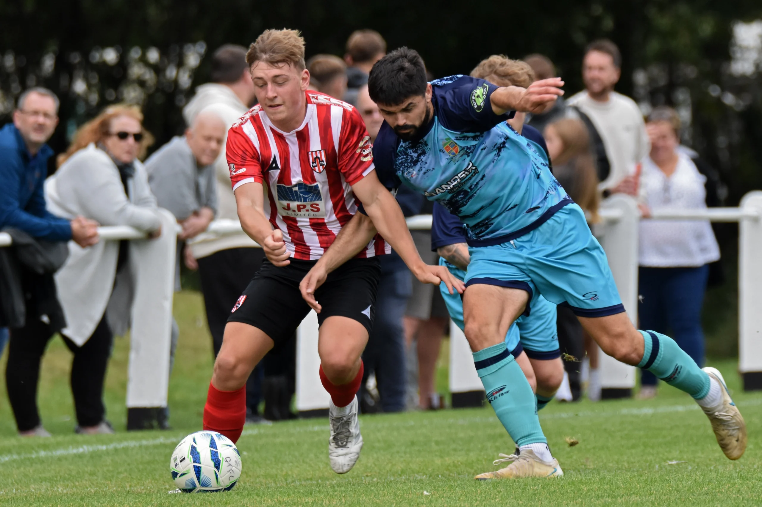 Thomas Birtles tussels with a Kendal Town opponent.