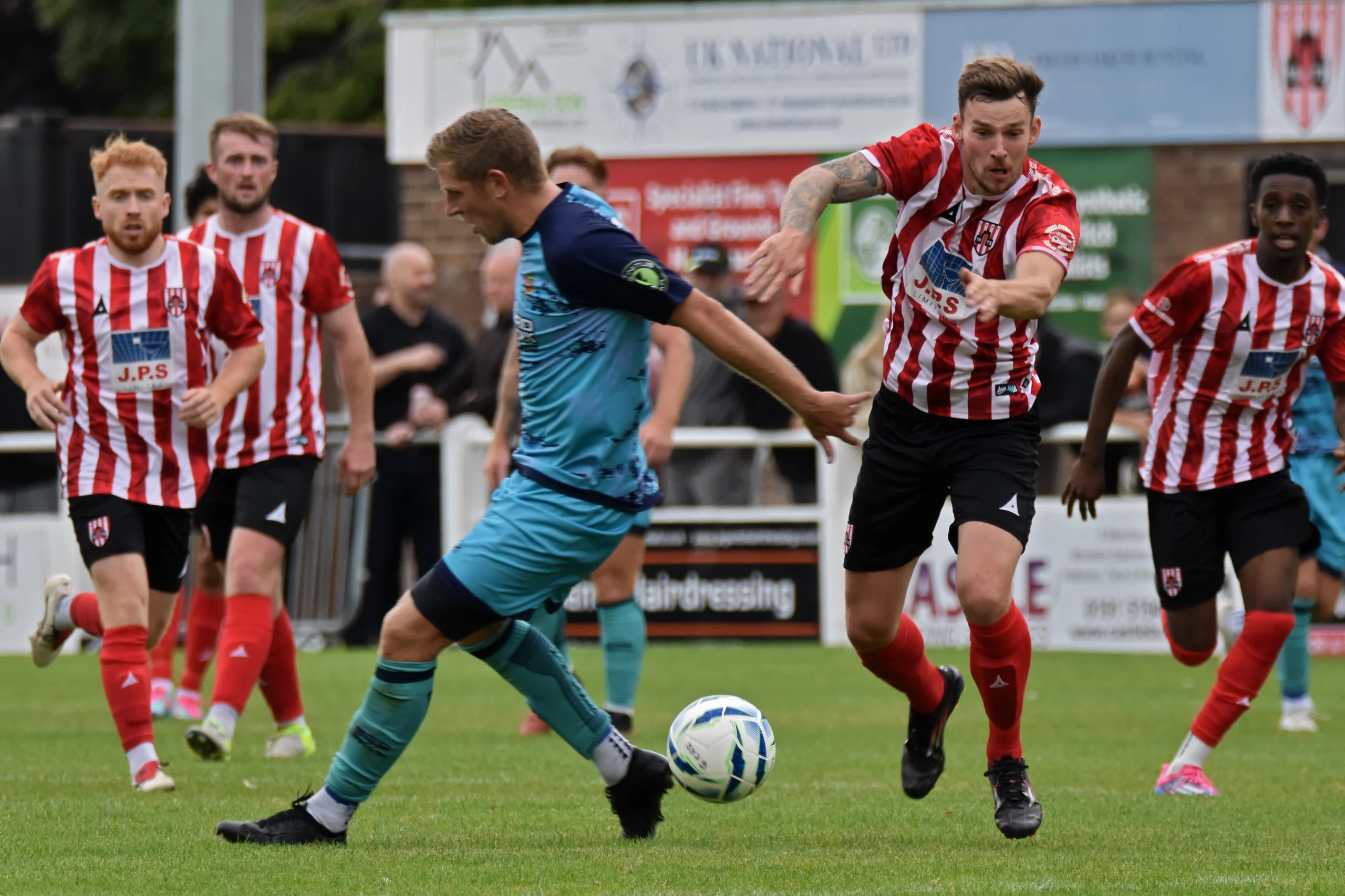 Kurtis Howes driving past a Kendal defender.