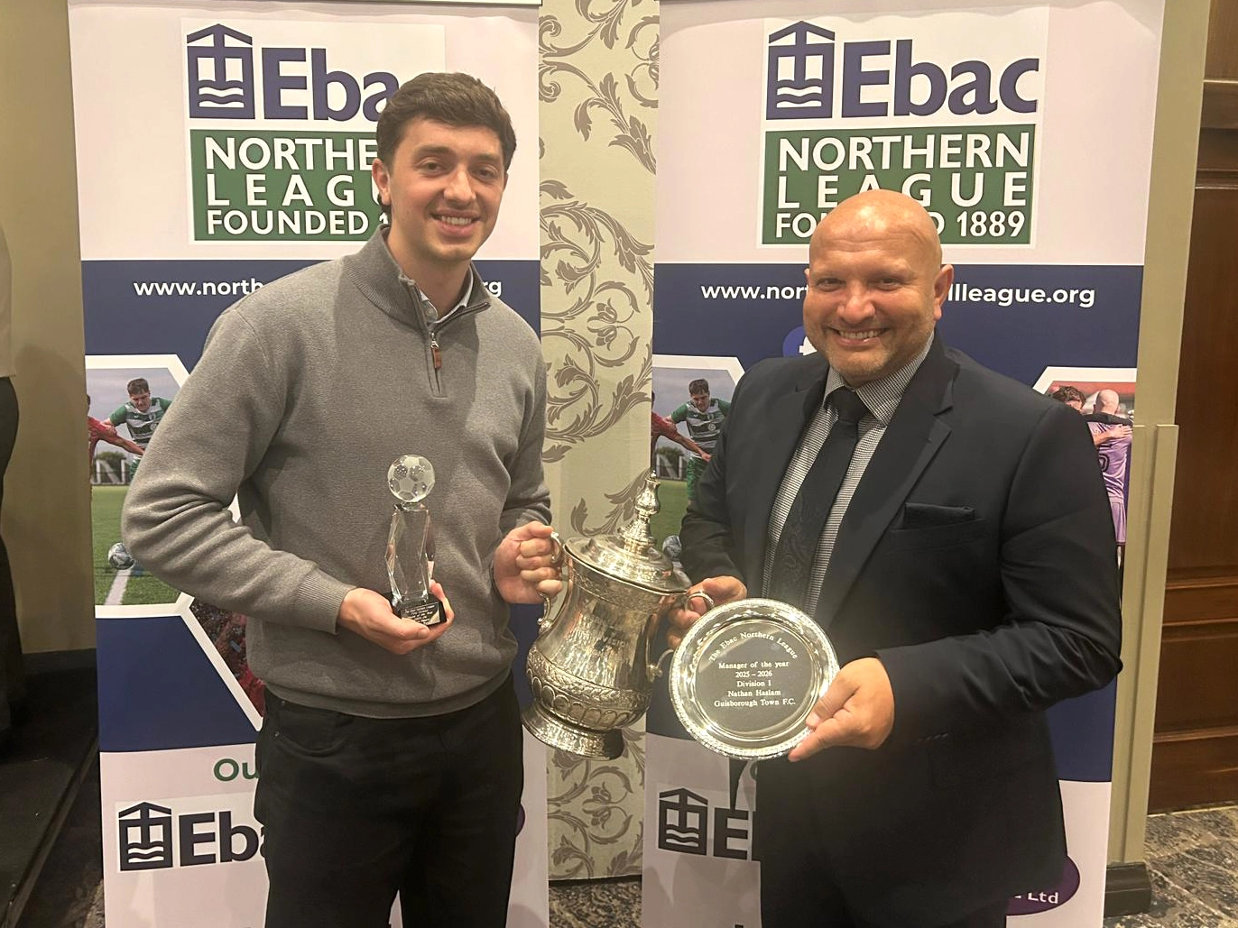 James Frazer and Nathan Haslam with their awards, and the Northern League Division One trophy.