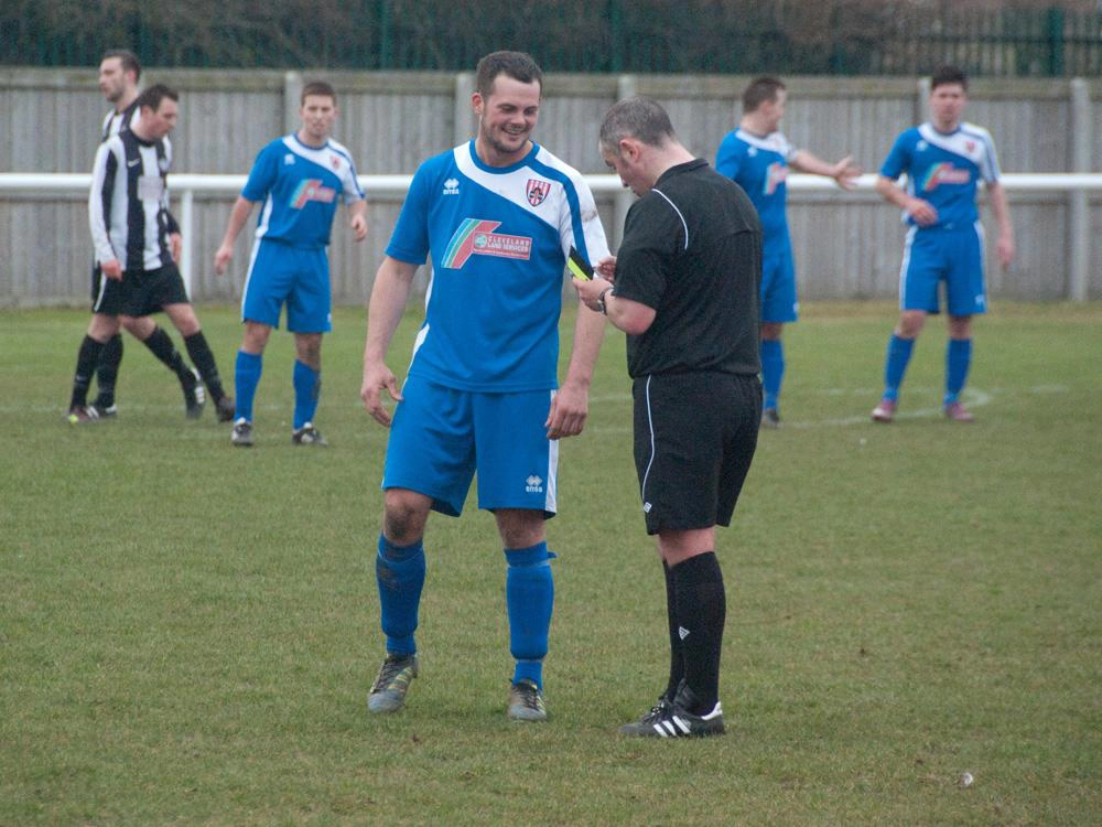 Gary Wood during his playing days picks up a yellow card.